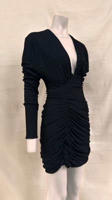 the dress is black and has long sleeves and a v - neck