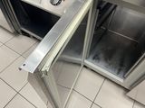 a stainless steel oven inside of a kitchen with a door open
