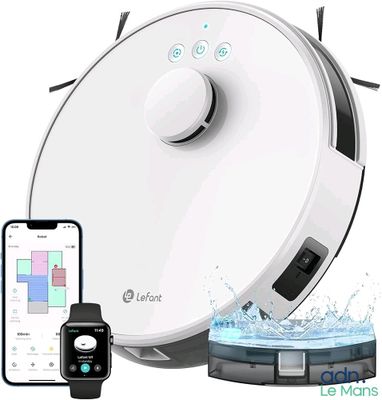 un gros plan d'un robot sophistiqué posé sur une table à côté d'un iPhone