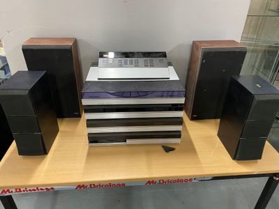 a lot of speakers on a table in a room