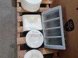 many plates and bowls on a pallet next to a motorcycle
