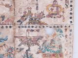 an old book with drawings on it sitting on top of a table
