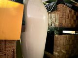 a large white vase sitting on top of a table