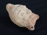 a clay figurine of a head with a face on it