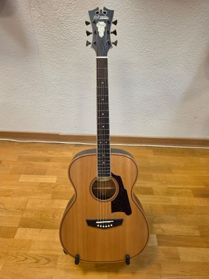 a guitar that is sitting on a stand on the floor