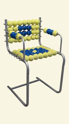 a chair made out of tennis balls on a metal frame