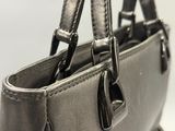 a close up of a handbag with a strap