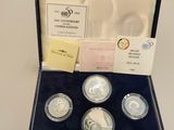 a set of four silver coins in a presentation case