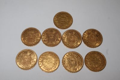 several gold coins are arranged in a triangle on a white surface