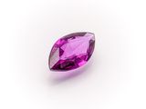 a close up of a purple gemstone on a white background