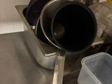 pots and pans are stacked on a metal counter in a kitchen