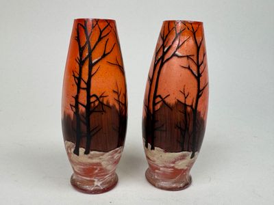 two vases that have been painted with trees on them