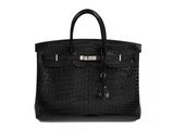 a black leather handbag on a white background