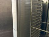 many trays of food that are on a rack in the kitchen