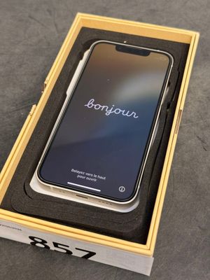an iphone in a box on a table with the box open