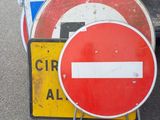 many signs that are sitting on the side of the road