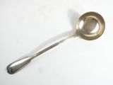 a silver spoon with a spoon handle on a white surface