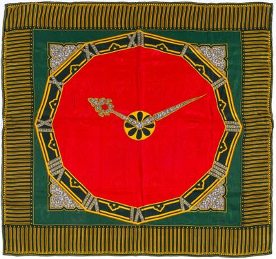 une image représentant une horloge rouge posée sur une nappe verte et jaune