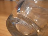 a close up of a glass on a wooden table