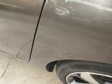 a close up of a car ' s door handle and tire