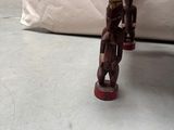 a toy figurine sitting on the floor in front of a couch