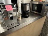 une cafetière et un micro-ondes posés sur un plan de travail