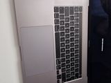 two laptops that are open on a white table