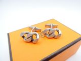 a pair of cufflinks that are sitting on a box
