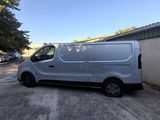 a silver van parked in a parking lot next to a building