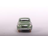 a green toy car that is sitting on a table