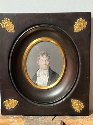 a picture of a picture of a man in a suit on a shelf