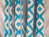 four blue and white decorative poles on a black background