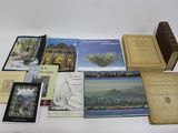 several books are sitting on a table with a white table cloth