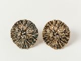 a pair of gold and black earrings on a white background