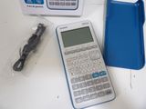 a calculator and a charger on a table