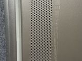 an image of a metal door with holes in it