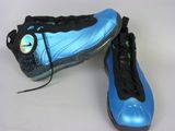 pair of blue and black shoes on a white surface with a white background