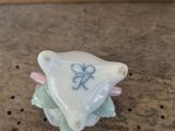 a small white and blue object on a wooden table