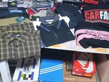 a table with a lot of clothing on top of it