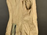 an image of a tan jacket on a mannequin stand