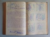 an open book with drawings on it on a table