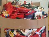 a cardboard box full of candy and candy bars on a pallet