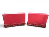 pair of red boxes with ruffled edges on a white background