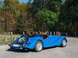 a blue car that is driving down the road