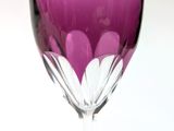 a purple wine glass with a white flower inside of it