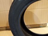 the tire of a car is sitting on the floor next to a cardboard box