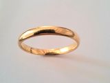 a close up of a gold ring on a white surface