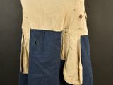 the back of a tan and blue jacket on a mannequin mannequin
