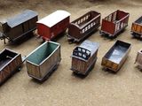many toy trains that are sitting on the ground