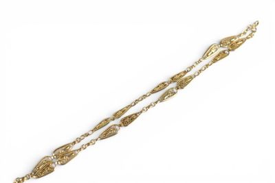 a close up of a gold bracelet with a chain on a white background